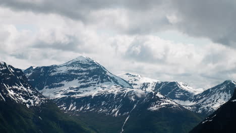 Moutain-range-with-snow-and-clouds-sorrounding-in-norway