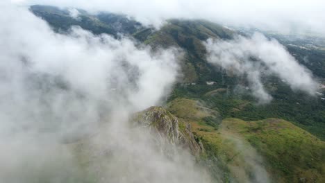 Drone-shot-flying-out-of-cloud-to-reveal-beautiful-mountain-landscape