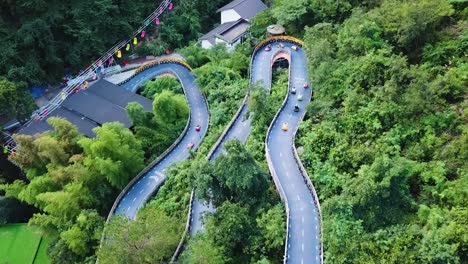 Aerial-drone-shot-of-the-hairpin-bend-Kart-Race-Track-in-theme-Park,-Tonglu,-China