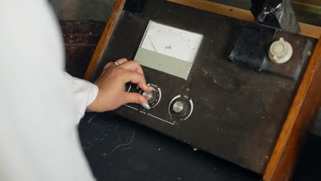 A-female-scientist-using-a-vintage-fluorometer