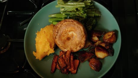 Establishing-Overview-of-Roast-Dinner-Plate-with-Roast-Potatoes,-Carrots,-Broccoli,-Green-Beans-and-Yorkshire-Pudding
