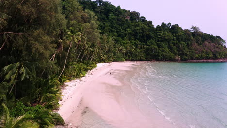Tropical-lagoon-with-waves-washing-upon-Koh-Kood-beach-with-palms