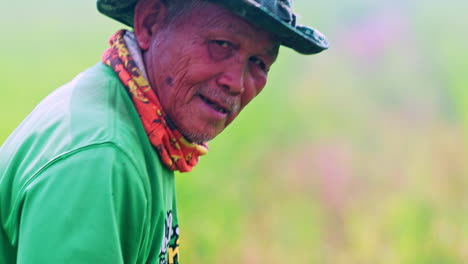 Asian-farmer-in-hat-working-in-rice-plantation-field-in-Thailand