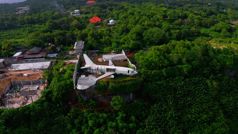 Retired-jet-plane-being-repaired-on-jungle-cliff-and-turned-into-hotel