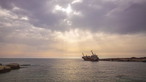 Timelapse-of-The-Edro-III-Shipwreck-with-Sun-Ray's-Beaming-Down-onto-the-Ocean-Surface-Through-the-Clouds