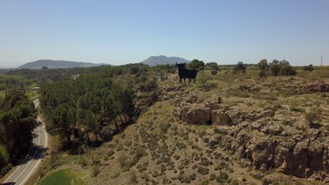 Drone-view-of-a-Spanish-classic-symbol,-the-bull-silhouette