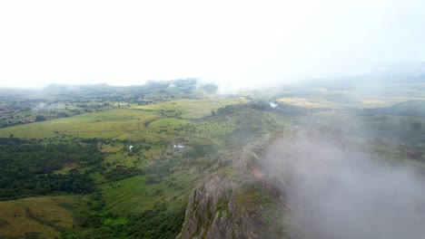 Drone-shot-flying-through-clouds-over-mountains-in-nature-of-Africa