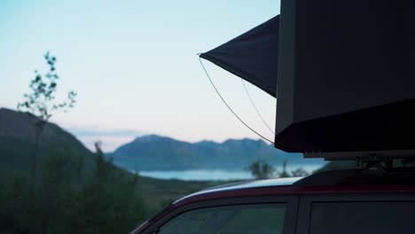 Close-Up-Of-SUV-With-Rooftop-Tent-Parked-Near-The-Scenic-Fjord-In-Flakstadvag,-Norway