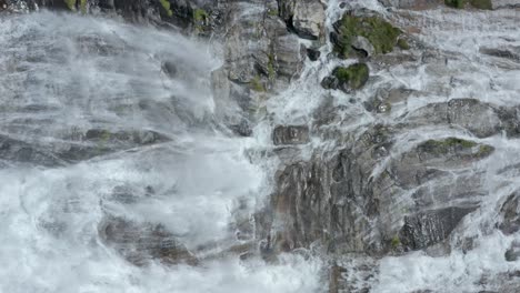 Large-volumes-of-fresh-water-plummets-down-rocky-cliff,-Cascata-del-Toce,-Italy