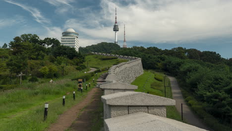Tourists-Walking-Along-Seoul-City-Wall-Historical-Fortification-or-Hanyangdoseong-in-Namsan-Tower-Park-on-Summer-Day,---Static-Daytime-Timelapse