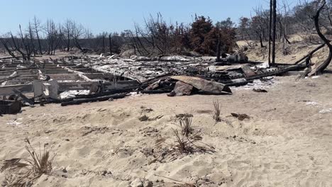 Remains-of-building-of-after-extreme-wildfires-in-Rhode,-motion-view