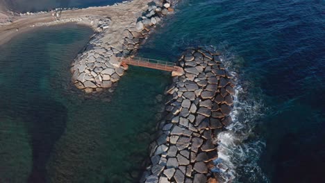 Stone-mole-breakwaters-protecting-beaches-from-coastal-erosion,-Cervo,-Liguaria