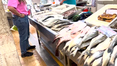 man-carefully-selects-fresh-seafood-for-dinner-at-the-Cascais-market