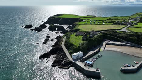 Aerial-coast-Ireland-picturesque-fishing-harbour-of-Boatstrand-Copper-Coast-Waterford-late-afternoon-in-summer