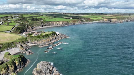 Aerial-coast-Ireland-safe-harbour-at-Boatstrand-Copper-Coast-Waterford-quaint-fishing-village-with-a-sheltered-harbour
