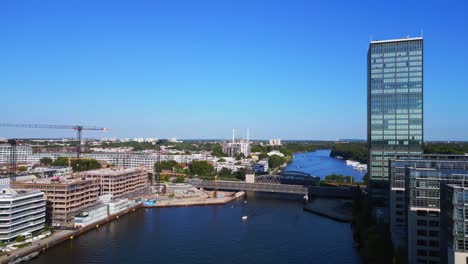 Beautiful-aerial-top-view-flight-bridge-skyscraper-Tower-on-border-river-Spree,-east-Berlin-Germany-evening-summer-23