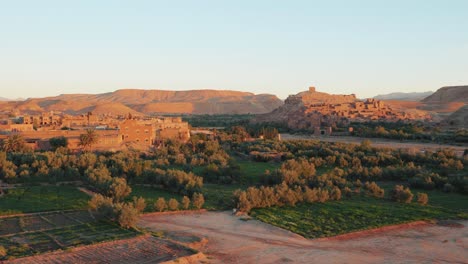 Wide-view-of-Ait-Ben-Haddou-fortress-and-desert-landscape-during-sunrise-in-Morocco