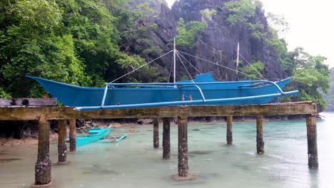 Traditional-colorful-Filipino-fishing-and-tour-boat-being-built-on-dry-dock-in-Palawan,-Philippines