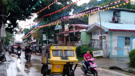 Filipino-tricycle-taxis-driving-down-the-street-during-Pintados-Kasadyaan-festival-celebration-in-Coron-Town,-Palawan-in-the-Philippines,-Southeast-Asia
