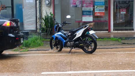 Motorbike,-tricycles-and-traffic-during-wet-and-rainy-monsoon-in-Coron-Town,-Palawan-in-the-Philippines,-Southeast-Asia
