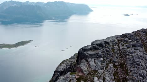 Aerial-View-Of-The-Ridge-And-Rocky-Cliffs-Of-Salberget-Hill-Overlooking-The-Fjord-In-Senja,-Norway