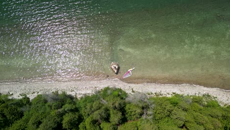 Aerial-topdown-shot-of-large-rock-on-lakeshore,-Michigan