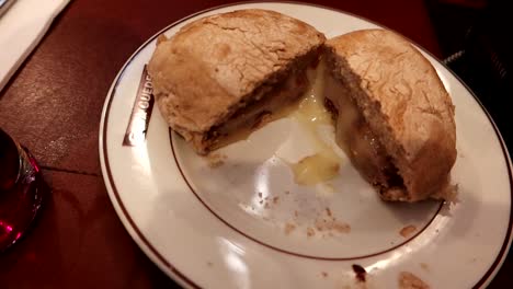 Handheld-closeup-view-of-a-Prego,-traditional-sandwich-dish-in-Porto
