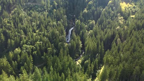 Gollinger-waterfall-spectacular-establishing-aerial-shot,-dolly-out,-golden-hour