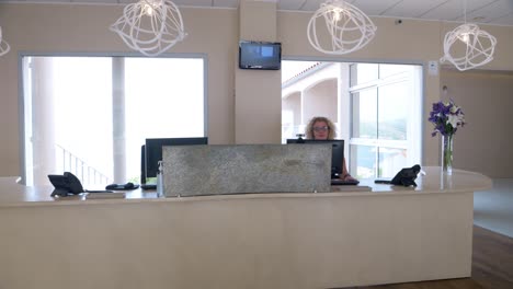Slow-motion-shot-of-a-receptionist-greeting-a-customer-at-a-spa-resort-in-France