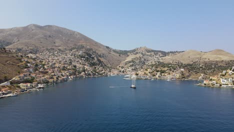 Aerial-dolly-to-mountainous-mediterranean-city-on-greek-island-Symi-in-summer