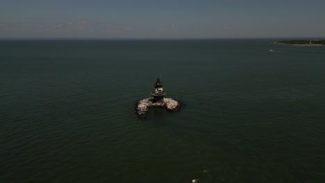An-aerial-view-of-the-Orient-Point-lighthouse-off-the-east-end-of-Orient-Point,-NY-on-a-sunny-day