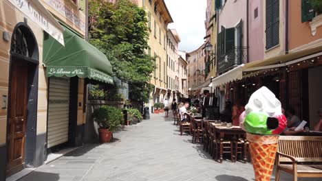 Walking-along-the-picturesque-streets-of-Lavanto-in-Northern-Italy,-showing-the-colourful-facades-and-restaurants
