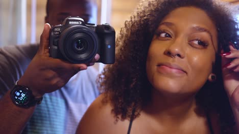 black-couple-having-a-fun-time-in-the-mirror-recording-themselves-while-the-woman-is-applying-make-up-before-going-to-a-photoshoot