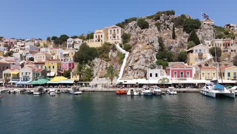 Waterfront-promenade-and-harbor-of-island-Symi-on-a-beautiful-summer-day