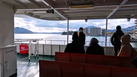View-on-deck-of-a-ferry-in-Japan-leaving-a-harbor