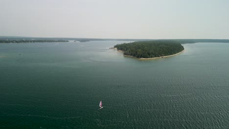 Aerial-flyout-of-windsurfer-on-Lake-Huron,-Michigan