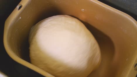 A-slow-panning-shot-of-dough-being-kneaded-in-a-bread-maker