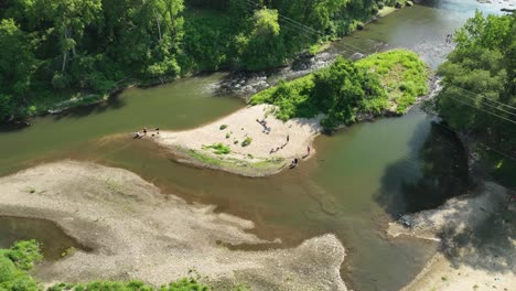 Aerial-hyperlapse-flying-around-summer-Zumbro-river-shore-with-people-enjoying-outdoor