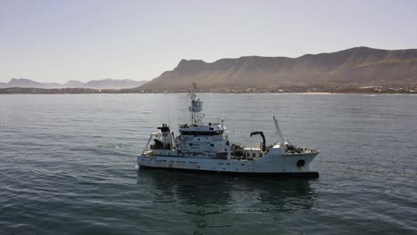 Marine-Research-motor-vessel-drifting-off-the-coast-operating-its-crane-and-equipment