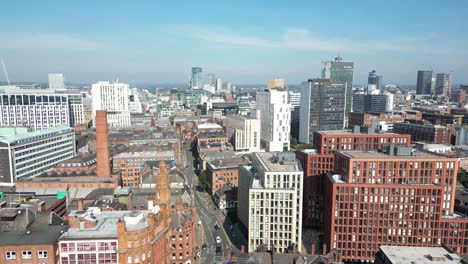 Aerial-drone-flight-over-the-rooftops-of-Sackville-Street-giving-a-view-of-the-Manchester-City-Centre-skyline