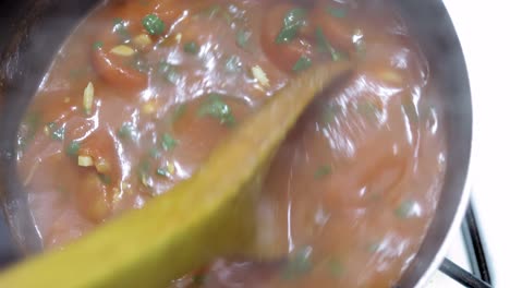 close-up-over-head-view-of-delicious-gourmet-home-made-tomato-sauce-in-a-hot-pot-with-the-steam-rising-from-the-boiling-food-while-being-stirred