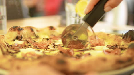 Slicing-pizza-with-a-specialized-pizza-cutter