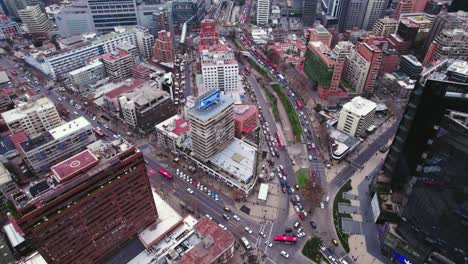 Flyover-of-streets-with-high-vehicular-traffic-and-red-public-transportation-buses-in-Santiago-Chile,-Tobalaba-sector