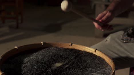 Animal-skin-drum-or-bass-drum-being-played-with-drumsticks
