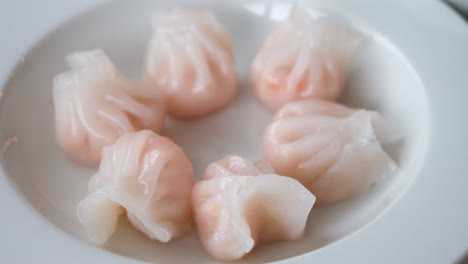 A-steamed-shrimp-dumpling-dish-is-displayed-on-a-table-as-part-of-a-Cantonese-culinary-food-and-dim-sum-experience
