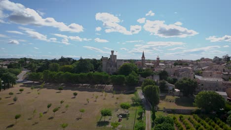 Aerial-establishing-shot-of-Chateau-Pouzihllac-from-over-a-field-of-vineyards