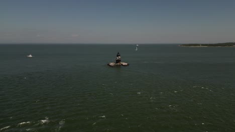 An-aerial-view-the-Orient-Point-lighthouse-off-the-east-end-of-Orient-Point,-NY-on-a-sunny-day