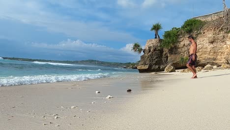 Male-Tourist-Walking-On-A-Scenic-Beach-In-Nusa-Lembongan-Island-In-Indonesia---slow-motion