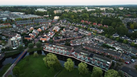 Aerial-overview-of-a-beautiful-green-suburban-neighborhood-in-the-Netherlands-at-dusk