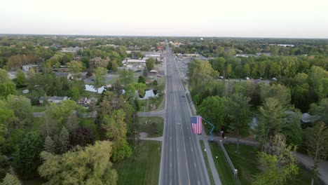 Highway-road-and-small-iconic-town-of-America,-aerial-drone-view